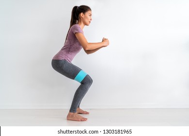 Resistance Band Fitness Woman Doing Squat Exercise With Fabric Booty Band Stretching Strap. Crab Walk Squatting Workout Girl Training At Home.