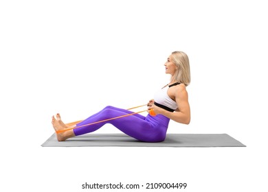 Resistance band seated back rows exercise. Attractive athletic woman sitting on a mat and work out using fitness props, isolated on white. - Powered by Shutterstock