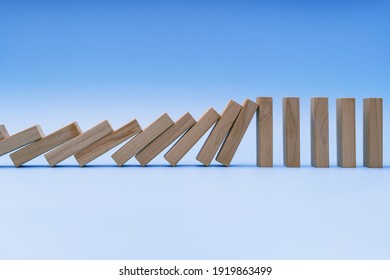 Resisting and Stopping Domino Effect Falls on Blue Background - Powered by Shutterstock