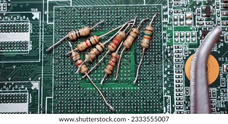 Resistors of different values on digital electronic circuit board. Electronic industry header. 