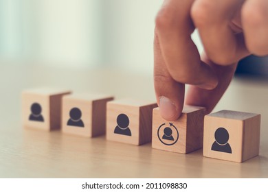 Re-skill concept to training employees on an entirely new set of skills for business growth and digital transformation. Man holds wood cube with re-skill icon on many staff icon symbol;  Copy space. 