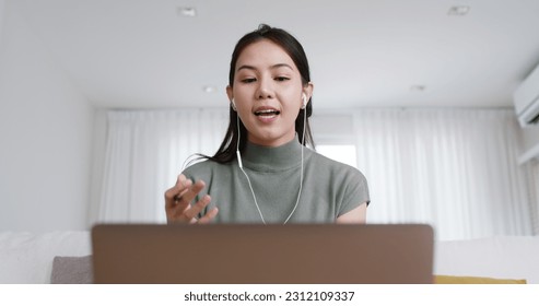 Reskill upskill for young adult talent workforce remote work at home hybrid workplace. Asia woman happy smile sit at sofa couch learn online study MBA video call share plan idea write note on tablet. - Powered by Shutterstock