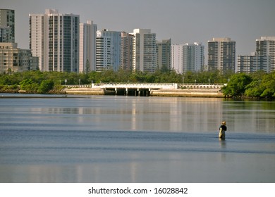 Resort Condo Towers Along Lake Worth Lagoon In Florida With Fisherman