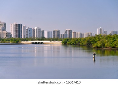 Resort Condo Towers Along Lake Worth Lagoon In Florida With Fisherman