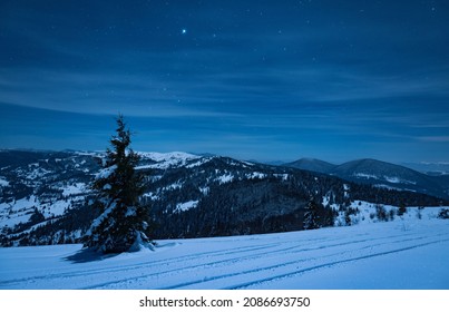 The Resort Ski Resort Illuminated At Night Is Located In A Picturesque Place Above A Clear Starry Sky. Country Vacation Concept. Place For Text