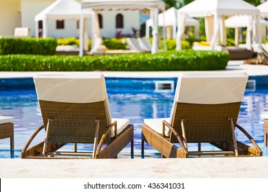 Resort Swimming Pool With Deck Chairs For Relaxation 