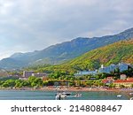 Resort town on the coast of Montenegro. Cove with boats on the Adriatic Sea, a small tourist town with beaches. Tourist trips, swimming in the sea with boats and buoys. Sanatoria casino and bouzas img