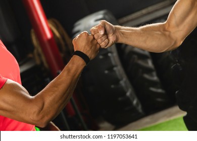 Respect in sport. Two muscular men are making fist bump gesture during workout in the gym. - Powered by Shutterstock