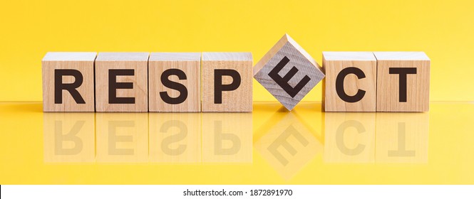 Respect word written on wood block. Respect word is made of wooden building blocks lying on the yellow table. Respect, business concept, yellow background - Shutterstock ID 1872891970