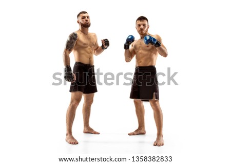 Respect for your opponent. Two professional fighters posing isolated on white studio background. Couple of fit muscular caucasian athletes or boxers fighting. Sport, competition, emotions concept.