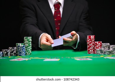 respectable casino worker in a tuxedo with a red tie serving  cards