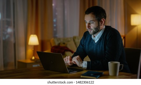 Respectable Looking Middle Aged Man Works on a Laptop from His House. His Apartment Has View on a Big City. Inside it's Warm and cosy. - Shutterstock ID 1482306122