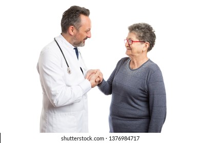 Respectful Medic Man Holding The Hand Of Elderly Female Patient Close To Chest Isolated On White Studio Background