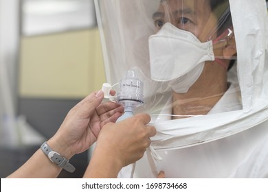 Respirator Fit Test Prepared For COVID-19. Asia Doctor Testing Repiratory System With N-95 Surgical Mask To Checks Properly Fits Face To Wears.