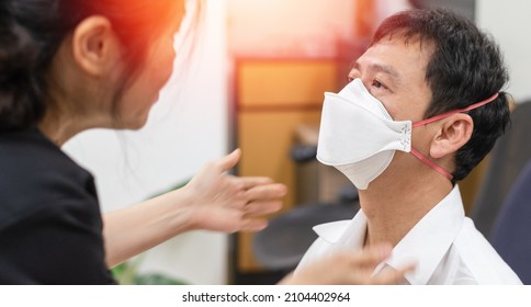 Respirator fit test prepared for COVID-19. Asia man testing repiratory system with N-95 surgical mask to checks properly fits face to wears. - Shutterstock ID 2104402964
