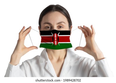 Respirator With Flag Of Kenya Doctor Puts On Medical Face Mask Isolated On White Background.