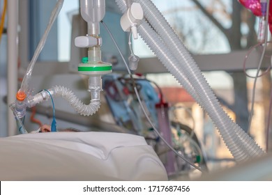 Respiratory Connection Tube, HME Filter, Carbon Dioxide Sensor And Suction Catheter, Patient Connected To Medical Ventilator In ICU In Hospital. On Background Hemodialysis Machine. 