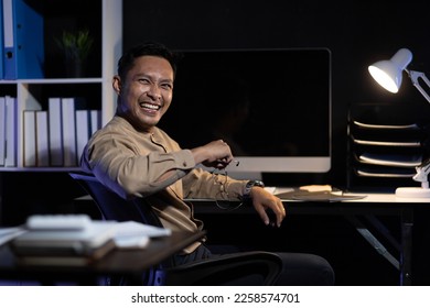 Responsible businessman working in night office trying overtime to achieve success of business project. Business people who have achieved success through hard work. - Shutterstock ID 2258574701