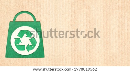 Responsible consumption. Arrows recycle symbol and shopping bag in paper cut style. Eco-friendly business. Horizontal banner with recycled eco paper texture. Copy space for text. Mock up template
