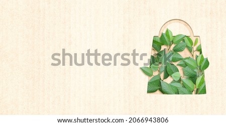 Responsible consumption. Green leaves and shopping bag in paper cut style. Eco-friendly business. Horizontal banner with recycled eco paper texture. Copy space for text
