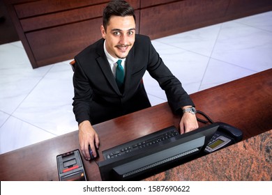 Responsible Hotel Service Worker Busy At His Job Position, Hotel Reception