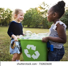 Responsible little girls cleaning at the park - Powered by Shutterstock