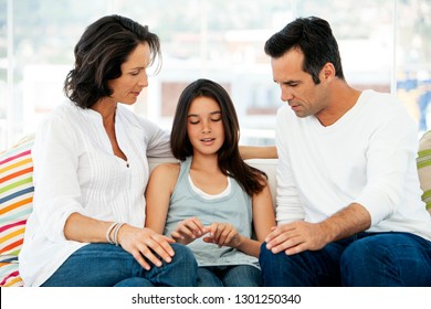 Responsible parents having discussion with teenage girl