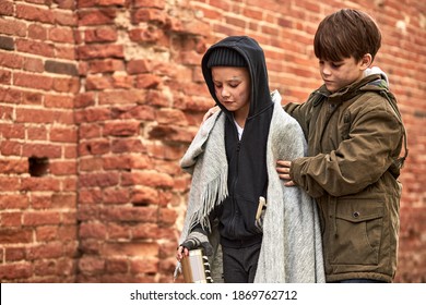 Responsive Child Boy Support Homeless Friend, Hugs Him, Try To Calm Down, They Want To Eat, Holding Jar For Money Donation. Street Children