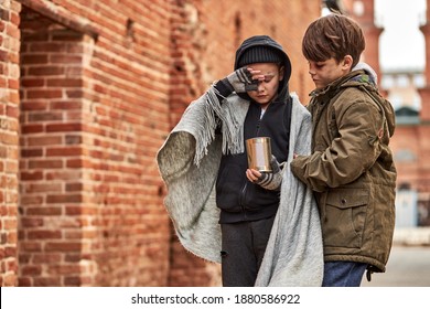 Responsive Child Boy Support Homeless Friend, Hugs Him, Try To Calm Down, They Want To Eat, Holding Jar For Money Donation. Street Children