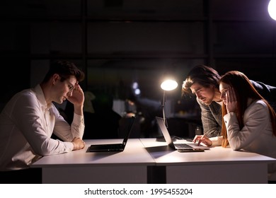 Responsive Director Or Manager Of Company Help Co-workers To Meet The Deadline, Having No Time To Sleep And Have Rest, Side View On Business People Working On Startup Project Together, Using Laptop