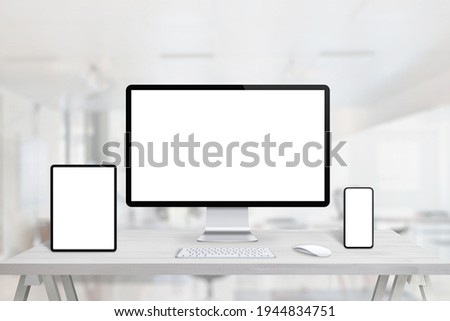 Responsive display devices mockup for web page presentation on office desk. Tablet, computer display and smart phone on office desk
