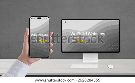 Responsive web design concept on phone and computer, studio portfolio page with We build websites headline