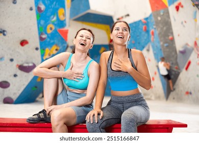 Rest after rock climbing - two friends exchange impressions about training at the climbing wall - Powered by Shutterstock