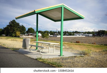 Rest area with bench and patio cover along river walkway in Tri-Cities Washington State                               
