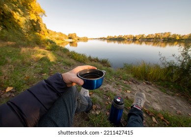 Rest By The Autumn River With A Cup Of Tea. Relax In The Autumn Nature Away From The City Noise. The Point Of View Of The First Person.