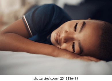 Rest, child and boy in bedroom, sleeping and calm in home, relax and comfortable on bed and thinking. Contemplating, kid and peaceful on mattress, tired and youth in weekend, sleepy and apartment - Powered by Shutterstock