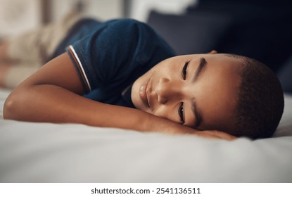 Rest, child and peaceful in bedroom, sleeping and calm in home, relax and comfortable on bed and thinking. Contemplating, kid and boy on mattress, tired and youth in weekend, sleepy and apartment - Powered by Shutterstock