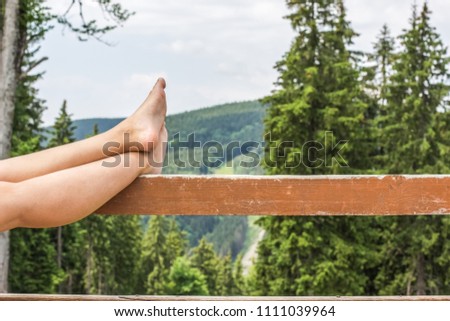 rest concept of woman bare feet on mountain unfocused green background 