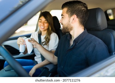 Rest Stop. Handsome Couple In The Car Taking A Break During A Road Trip And Drinking A Soda Can