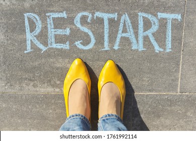 Restart Concept, Top View On Woman Legs And Text Written In Chalk On Gray Sidewalk.