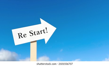 Restart! Lettered Arrow Signpost In The Blue Sky Background