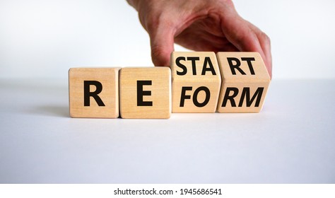 Restart and reform symbol. Businessman turns cubes and changes the word 'restart' to 'reform'. Beautiful white background. Business and restart - reform concept. Copy space.