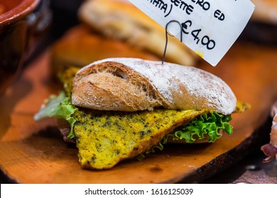 Restaurant Bakery Retail Display Of Panini Sandwich Bread With Green Garlic Eggs For Lunch In Shop Store In Florence, Italy Market With Sign And Price