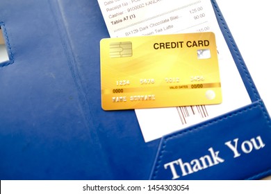 Restaurant Bill Receipt Holder With Credit Card And Cash Money On Cafe Wooden Desk. 