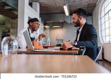 Restaurant business manager sitting and talking with chef. Restaurant owner having a conversation with employee. - Powered by Shutterstock