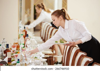 Restaurant catering services. waitress serving banquet table
