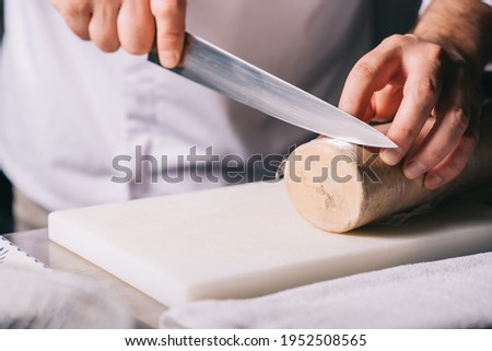 restaurant chef cutting foie gras