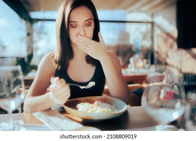 Restaurant Customer Eating her Meal Feeling Sick.Woman suffering after having an altered cooked meal 
