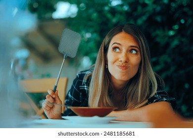 
Restaurant Customer Using a fly Swatter Bothered by insects. Customer upset on a diner invested with mosquito flies 
