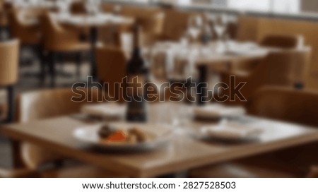A restaurant dining table is set with a wine bottle, glasses, and a small plate of food, ready for guests.